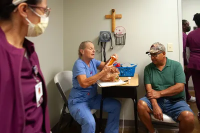 RN Lorie LeJeune sorts through patient Eduardo Navarreteâs prescriptions at a medical clinic provided free of charge to local residents in Hope, Ark. on Sept. 7, 2023. Photo by Rory Doyle.